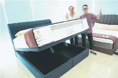  ??  ?? Dreamland area sales manager Bernard Chin (right) and Kho introduce the latest Dreamland Weave headboard and bed frame with storage.