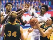  ?? Charlie Riedel Associated Press ?? JARIUS COOK, lower right, of North Dakota State comes up with the loose ball against No. 7 Kansas.