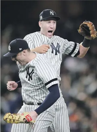  ?? Elsa Garrison Getty Images ?? GREG BIRD, left, and Todd Frazier celebrate the Yankees’ 6-4 victory over the Astros in Game 4 of the American League Championsh­ip Series. New York overcame a 4-0 deficit.