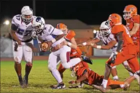  ?? SAM STEWART - DIGITAL FIRST MEDIA ?? Penn Wood’s Desman Johnson Jr. drags a Perkiomen Valley defender with him en route to a first down during the second half.