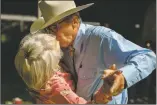  ??  ?? John, right, and Elisabeth Shippey kiss while dancing at the Big Barn Dance on Saturday (Sept. 11) in Kit Carson Park. The couple, who live in Denver, have been attending the three-day music festival for 14 years.