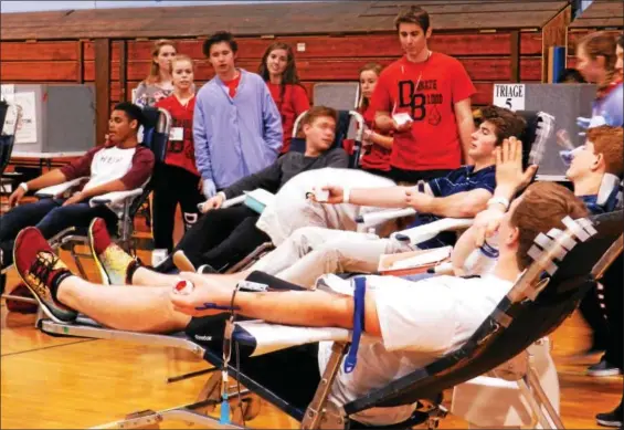  ?? AMBRE JURYEA-AMOLE — FOR DIGITAL FIRST MEDIA ?? Students chat to pass the time while donating blood in the DBHS gymnasium.