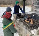  ?? ?? Youths cook hot dogs on an outdoor firepit in Wakamow Valley. Photo courtesy Curtis Hallborg