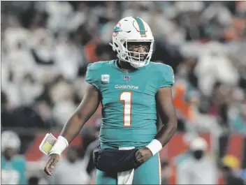  ?? AP PHOTO/JEFF DEAN ?? Miami Dolphins quarterbac­k Tua Tagovailoa looks to the sidelines during the first half of an NFL football game against the Cincinnati Bengals, on Sept. 29 in Cincinnati.