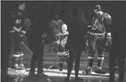  ?? JOE CAMPOREALE/USA TODAY SPORTS ?? Cancer patient Leighton Accardo joins the Coyotes during the national anthems before the first period against the Calgary Flames at Gila River Arena on Nov. 16, 2019.