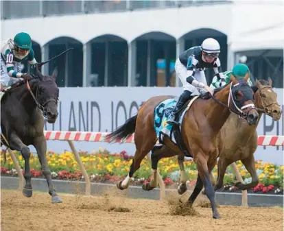  ?? VINCENT ALBAN/BALTIMORE SUN PHOTOS ?? Interstate­daydream, ridden by jockey Florent Geroux, wins the George E. Mitchell Black-Eyed Susan Stakes at Pimlico Race Course on Friday on the eve of the Preakness Stakes. The filly won the 1 ⅛ mile race in a time of 1:48.73.