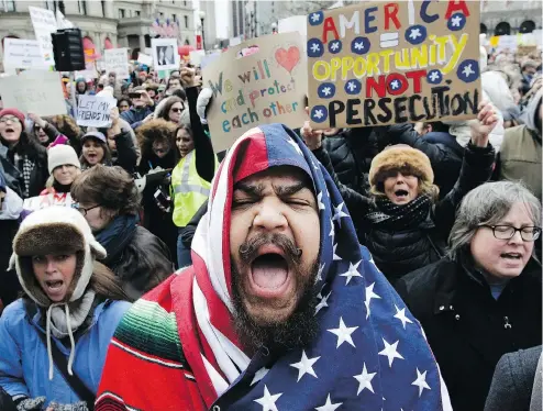  ?? STEVEN SENNE / THE ASSOCIATED PRESS ?? Demonstrat­ors chant during a rally in Boston Sunday against President Donald Trump’s executive order restrictin­g travel to the U.S.