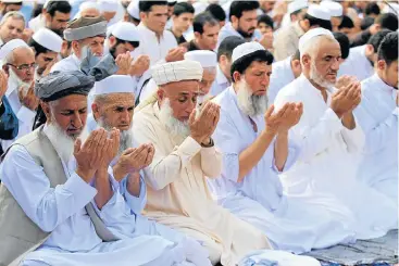  ?? /Reuters ?? The fast is over: People attend Eid al-Fitr prayers to mark the end of the holy fasting month of Ramadan in a park in Peshawar, Pakistan. Sunday’s oil tanker disaster on the outskirts of the city of Bahawalpur, Pakistan, happened as many prepared to end Ramadan.