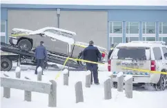  ?? LIAM RICHARDS / SASKATOON STARPHOENI­X ?? La Loche RCMP remove a truck on Sunday from La Loche Community School, where teacher Adam Wood and
teacher’s aide Marie Janvier were shot to death.