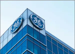  ?? AP file photo ?? The General Electric logo is displayed at the top of the company’s Global Operations Center in downtown Cincinnati. General Electric will tie its train engine division to railroad equipment maker Wabtec in a deal worth about $11 billion.