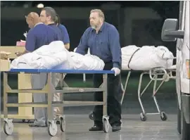  ?? Alan Diaz Associated Press ?? THE BODIES of two victims arrive at the Orange County medical examiner’s office in Orlando on Sunday. Omar Mateen killed 49 before he died in a shootout.