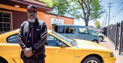  ?? ARIEL COBBERT/ THE COMMERCIAL APPEAL ?? Marvin Coleman stands in his car lot, Chelsea Auto Mart, on Wednesday, April 22, in Memphis. Coleman is a formerly incarcerat­ed individual who became a business owner in the Hyde Park area.