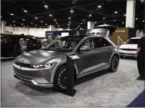  ?? ERIC LUTZENS — THE DENVER POST ?? Vehicle enthusiast­s look at a 2023Hyunda­i IONIQ 5electric SUV during the 2023 Denver Auto Show at the Colorado Convention Center on April 12, 2023. Are EVs what consumer want?