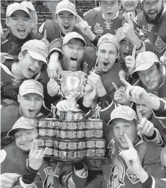  ??  ?? Members of the Acadie-Bathurst Titan celebrate with the Memorial Cup after defeating the Regina Pats on Sunday night in Regina.