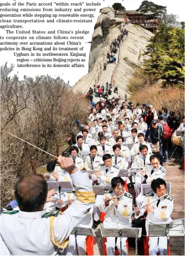  ?? TAO MING/XINHUA ?? BELOW Mount Huashan in northwest China’s Shaanxi Province is a brass symphony orchestra performing for visitors to the tourist destinatio­n.