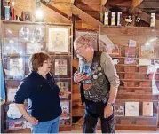  ??  ?? Petra Hebert, from Prague, Oklahoma, and is of Czech descent, speaks with Frantisek Hrubacek, who is with a group of tourists from the Czech Republic, at the Round Barn.