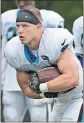  ?? Chuck Burton / AP ?? Carolina Panthers’ Christian McCaffrey runs with the ball during practice at team training camp at Wofford College in Spartanbur­g, S.C.