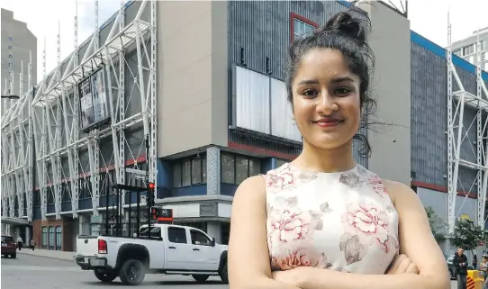  ?? DAVE SIDAWAY ?? Safia Ahmad poses in front of the Cinéplex Forum, which was known as the AMC Theatre when she got her first job there as “a hormonal and insecure teenager.”