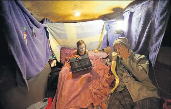  ?? Photog r aphs by Genaro Molina Los Angeles Times ?? THE “safe parking” program takes 115 autos off the streets overnight. Above, Thomas Goodwin and daughter Leilani prepare to sleep in their van in Santa Barbara.