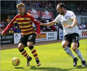  ?? Picture: SNS ?? Thistle star Craig Slater holds off Ayr United’s Michael Moffat last week