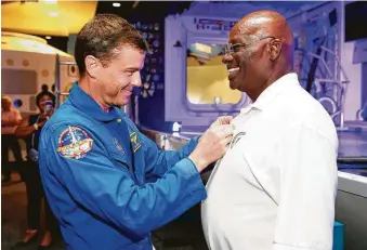  ?? Michael Wyke / Contributo­r ?? Astronaut Reid Wiseman, left, awards Victor Murray a Silver Snoopy, which is given to less than 1 percent of the aerospace workforce each year, Thursday during his 50th anniversar­y party.