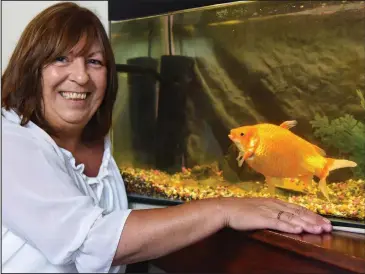  ??  ?? Big fish: Owner Anne Cooper with Big Bob – who has already outgrown four tanks