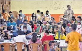  ?? PTI ?? Beneficiar­ies wait to receive a dose of Covid-19 vaccine at Parel vaccinatio­n centre in Mumbai on Friday.