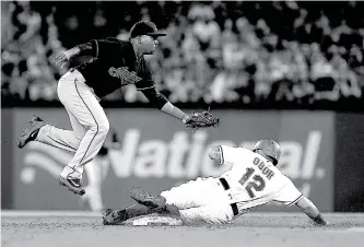  ?? Associated Press ?? n Cleveland Indians second baseman Jose Ramirez forces out Texas Rangers’ Rougned Odor on Tuesday during the second inning in Arlington, Texas.