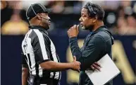  ?? Chris Graythen / Getty Images ?? Interim coach Steve Wilks of the Carolina Panthers talks with an official during the second half against the Saints on Jan. 8.