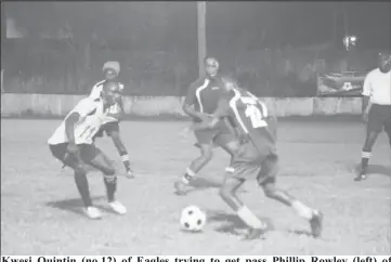  ??  ?? Kwesi Quintin (no.12) of Eagles trying to get pass Phillip Rowley (left) of Western Tigers while Michael Pedro and Clive Nobrega watch on in the 2nd Annual Petra Organizati­on/Limacol Football Championsh­ip at the GFC ground Bourda