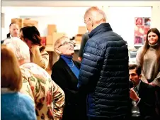  ?? — AFP photo ?? Biden speaks with people during a stop at a candle shop called 1820 Candle Co. in East Palestine, Ohio.