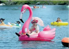  ?? DAVE JOHNSON/POSTMEDIA NEWS ?? This Welland Floatfest participan­t, on a giant pink flamingo inflatable, was ready for the scorching sun Sunday on the Welland Recreation­al Canal.