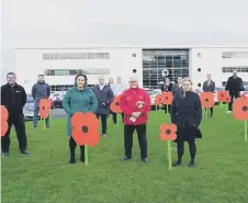  ?? ?? Supporters of the Remembranc­e Day tribute at the business park.