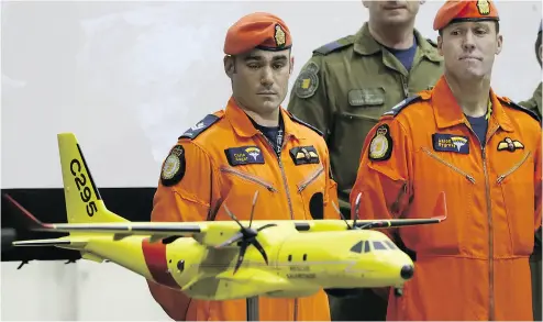  ?? LARS HAGBERG / THE CANADIAN PRESS FILES ?? Master Cpl. Chris Auger and Warrant Officer Aaron Bygrove look at a model of the Airbus C295 at CFB Trenton on Dec. 8 as the government announces Airbus has won the new search-and-rescue aircraft contract.