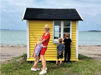  ?? ?? ‘Nordic children eat differentl­y, learn differentl­y, play, dress, even sleep differentl­y: HelenRusse­ll with her young family.