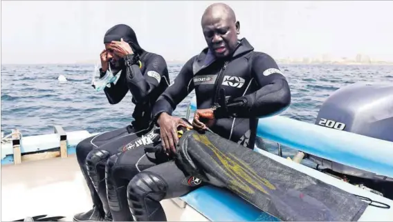  ??  ?? Endless search: Underwater archaeolog­ist Ibrahima Thiaw and a team member during an expedition to find slave shipwrecks off the island of Gorée. Photo: Seyllou/AFP