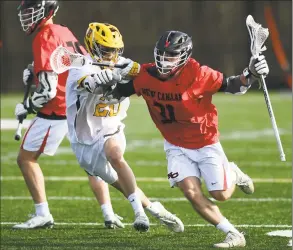  ?? Erik Trautmann / Hearst Connecticu­t Media ?? Brunswick’s Lucas Delgado (20) and New Canaan’s Ryan Caione (31) battle it out in their boys lacrosse game on Saturday in New Canaan.