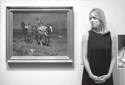  ?? JAE C. HONG/THE ASSOCIATED PRESS ?? LEFT: Chief curator Amy Scott stands next to a painting titled First Streak of Dawn by Frank Tenney Johnson on Friday at the Autry Museum of the American West in Los Angeles. In 2008, when the Coeur D’Alene Art Auction of Nevada sold a record $36.8...