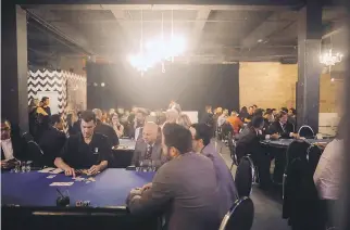  ??  ?? Game time: Patrons sit down for VIP poker at the Casino contre le cancer benefit.