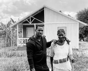  ?? PHOTO BY AINSWORTH MORRIS ?? Jamaican sprinter Yohan Blake and Irene Morgan standing before her new house recently. Blake financed the constructi­on as Morgan’s Mother’s Day gift.