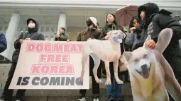  ?? AHN YOUNG-JOON/AP ?? Activists rally around a bill banning the production and sales of dog meat Tuesday at the National Assembly in Seoul, South Korea. The legislatio­n passed 208-0.