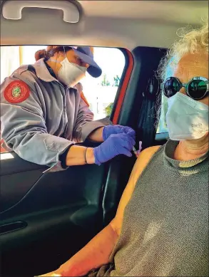  ?? Associated Press ?? This undated photo provided by Tami Katz–Freiman, of Miami, shows her getting a COVID-19 vaccine. Katz-Freiman, 65, got her second dose, and plans to watch the Miami Film Festival virtually Sunday, at the home of unvaccinat­ed friends. All will wear masks. The Biden administra­tion said Friday, March 5, it’s focused on getting the guidance for those fully vaccinated right and accommodat­ing emerging science.