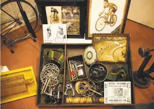  ?? Photos by Sarah Rice / Special to The Chronicle ?? The U.S. Bicycling Hall of Fame museum includes exhibits from the velodrome days of bicycle racing, above, and medals, left. Below: Bob Bowen, president of the hall, discusses the features of a penny-farthing bike on display.