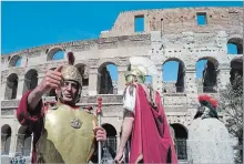  ?? VIRGINIA MAYO THE ASSOCIATED PRESS ?? People dressed as gladiators stand in front of the Colosseum in Rome, Italy. One can hardly see the treasures of Rome’s top attraction­s these days without bumping arms with the hordes of tourists.