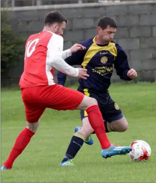  ??  ?? Paul Culleton of Rosslare Rangers tries to shake off the attentions of Dave Millar.