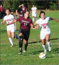  ?? Photos by Ernest A. Brown ?? Alexandria Lorenzo (10) and the undefeated Tolman girls soccer team posted a 3-2 victory over senior Abbie Roderick (11) and Woonsocket Friday afternoon at Barry Field.