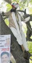  ?? HANDAN KHANNA/AFP/GETTY IMAGES ?? Gajendra Singh Rajput stands on a tree before committing suicide during an Aam Aadmi Party rally in New Delhi on Wednesday.