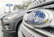  ?? ASSOCIATED PRESS FILE PHOTO ?? Ford vehicles sit on the lot at a car dealership in Brandon, Fla.