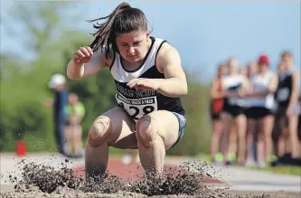  ?? CLIFFORD SKARSTEDT EXAMINER ?? Adam Scott's Ellie Murdock kicks up sand on her landing in the running long jump during the Kawartha Track and Field event on Thursday at theThomas A. Stewart Secondary School athletic field.