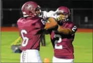  ?? AUSTIN HERTZOG - DIGITAL FIRST MEDIA ?? Pottsgrove’s Rahsul Faison (2) is congratula­ted by Desmond Austin after one of his four first-half touchdowns Friday against Pottstown.